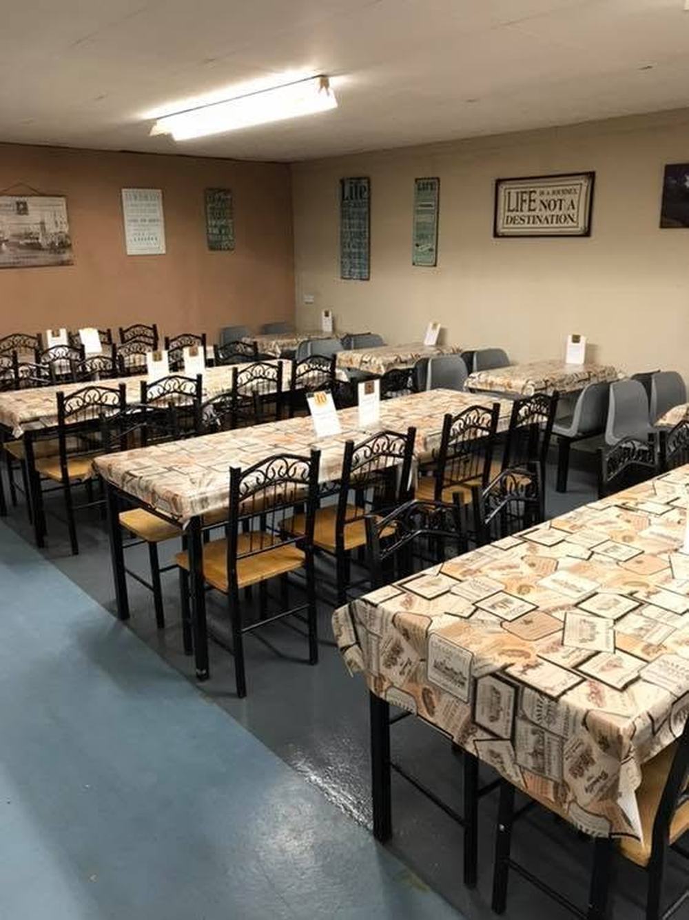 The Corner Café seating area, with long tables and chairs set up for families and groups