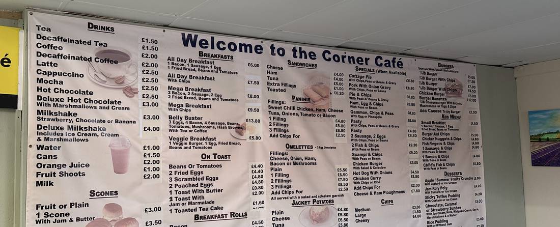 The full Corner Café menu board mounted on the wall above the seating area